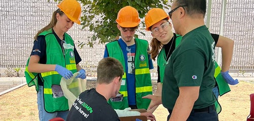 A CERT San Diego instructor teaching volunteers how to apply a splint to an arm